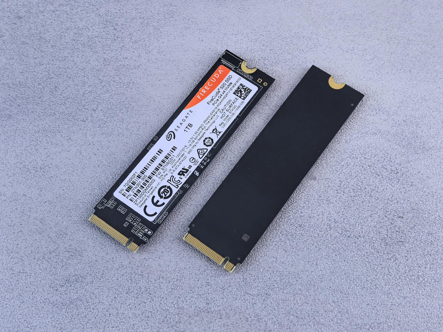 Dwa dyski SSD NVMe Seagate FireCuda leżące na szarym tle