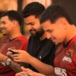 Trzech młodych graczy rywalizuje w mobilnym turnieju e-sportowym